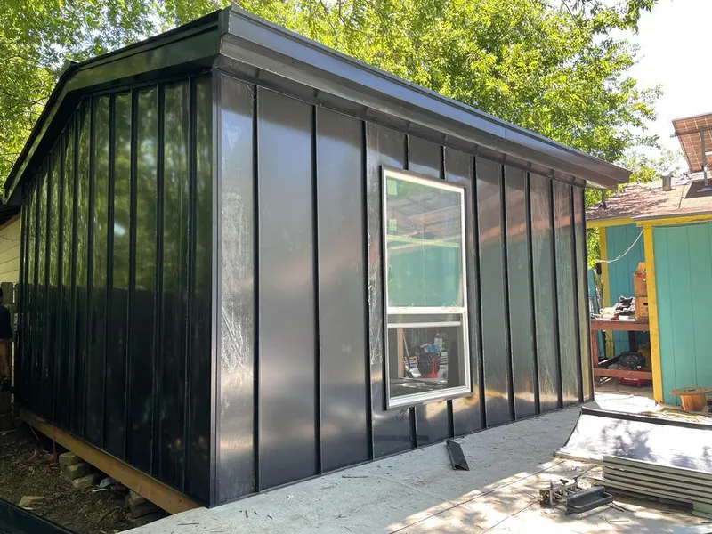 Black standing seam metal wall panels for Roof Inspection in Baxter