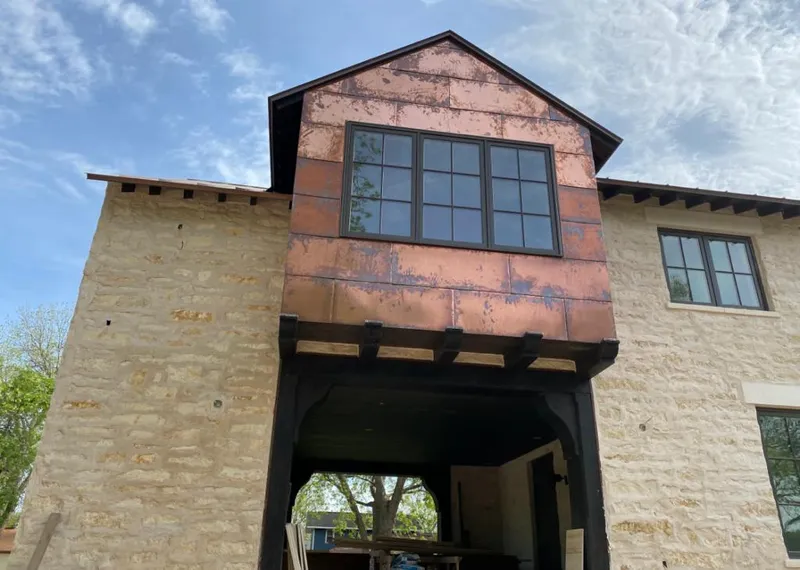 Copper metal panel facade on a stone building for Metal Roof Coating in Baxter